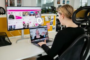 a woman sitting at a desk using a laptop computer